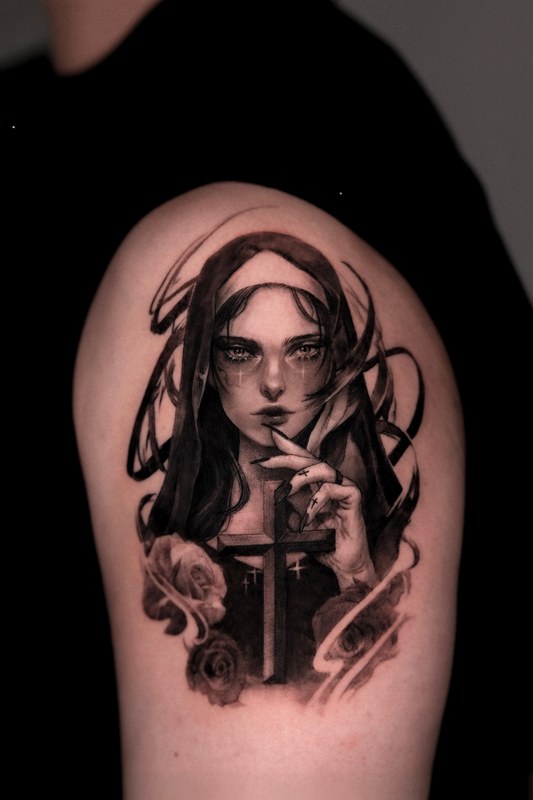 A woman's portrait tattooed on the arm