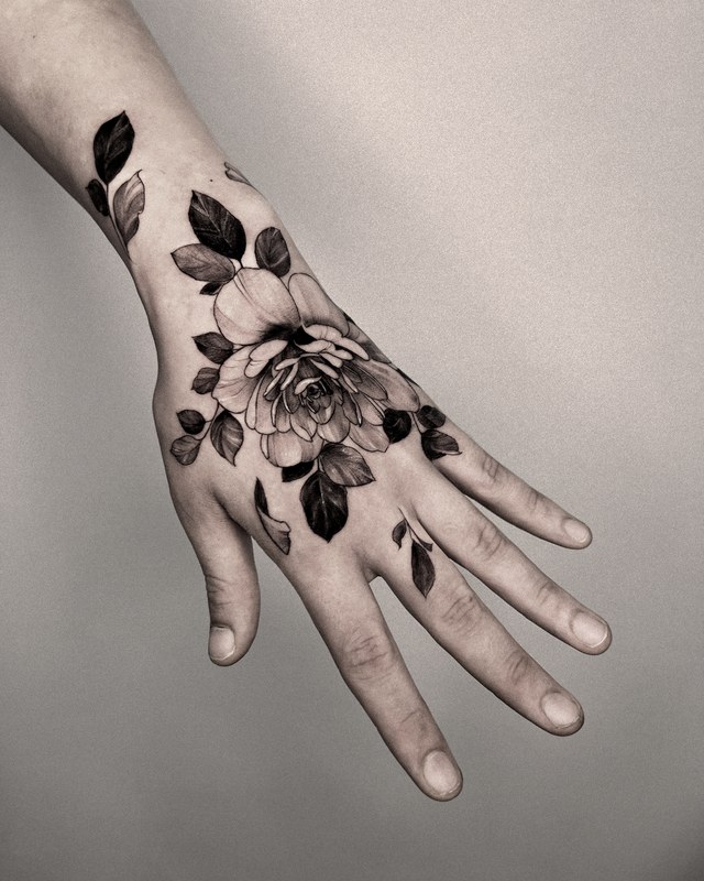 A rose tattooed on the back of the hand