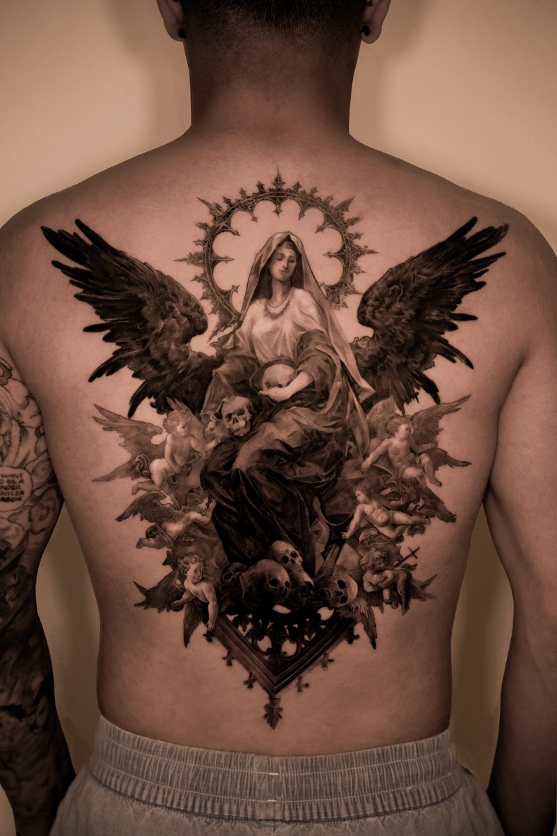 A large black-and-grey Virgin Mary piece covering the back