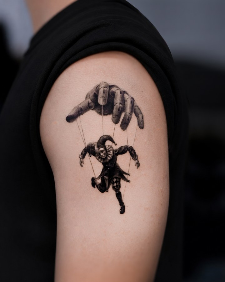A marionette tattooed on the arm
