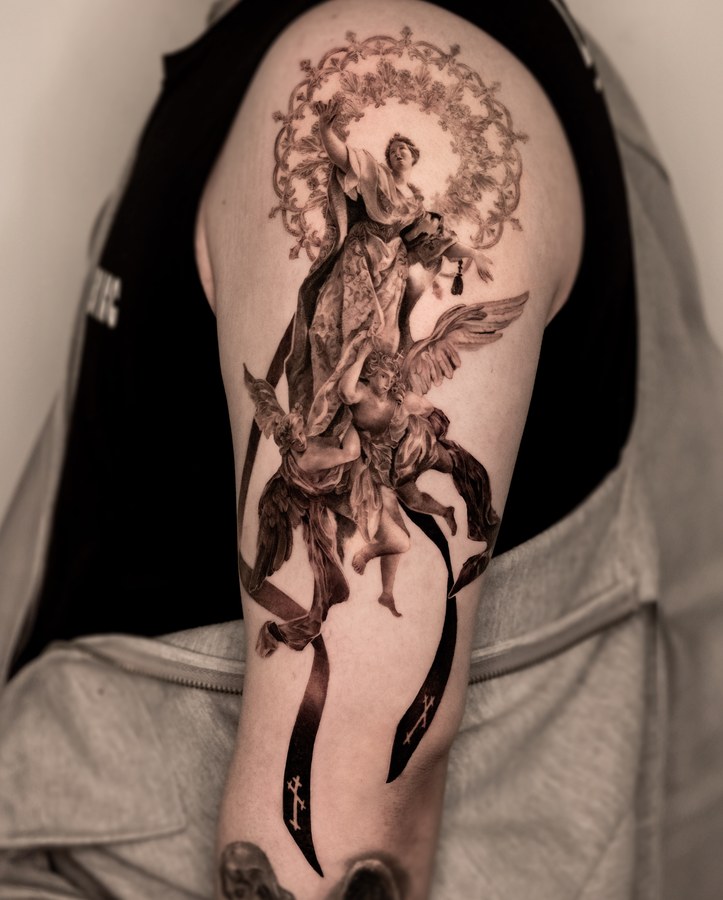 A religious piece running from the shoulder down the arm