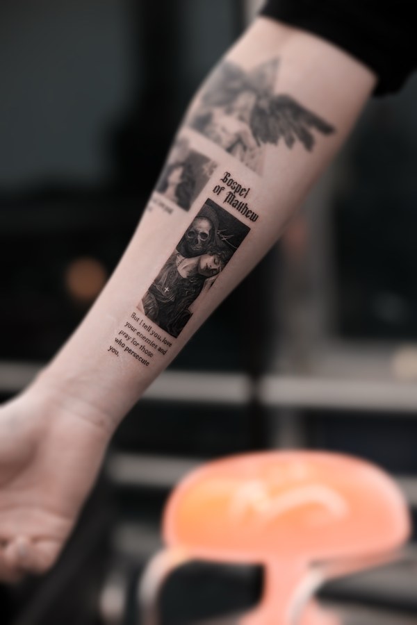 A patchwork of religious imagery tattooed on the arm