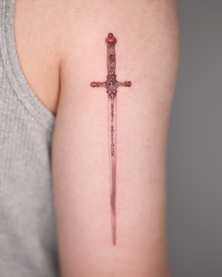 A sword tattooed on the inner arm