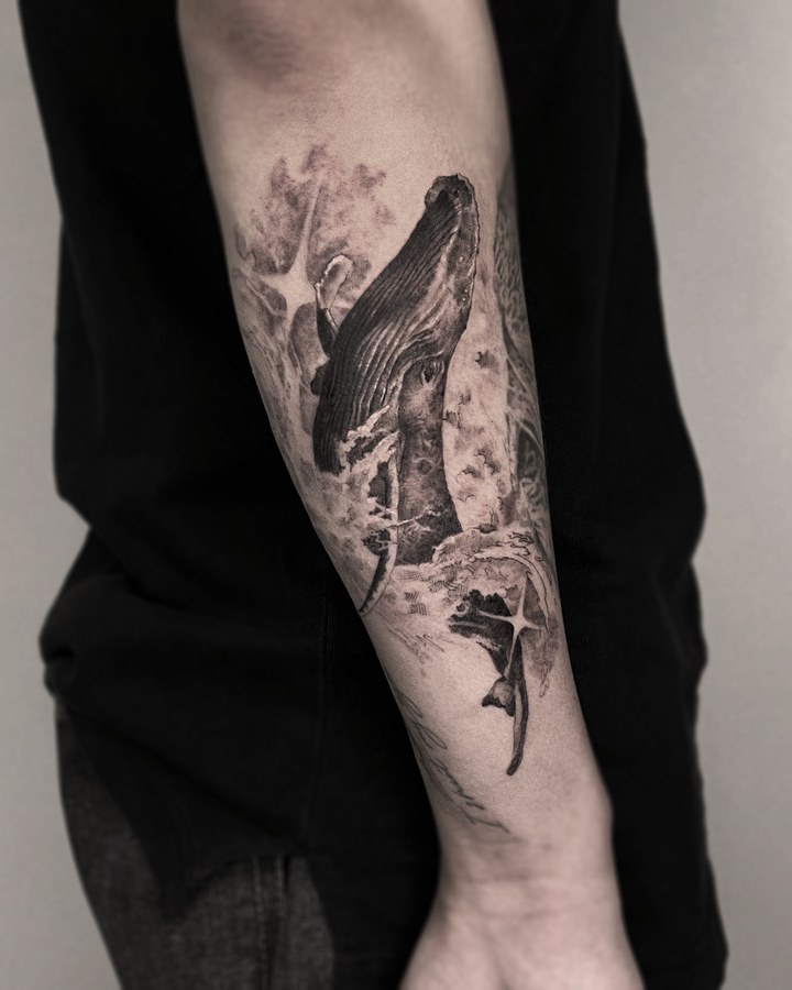 A whale tattooed on the arm