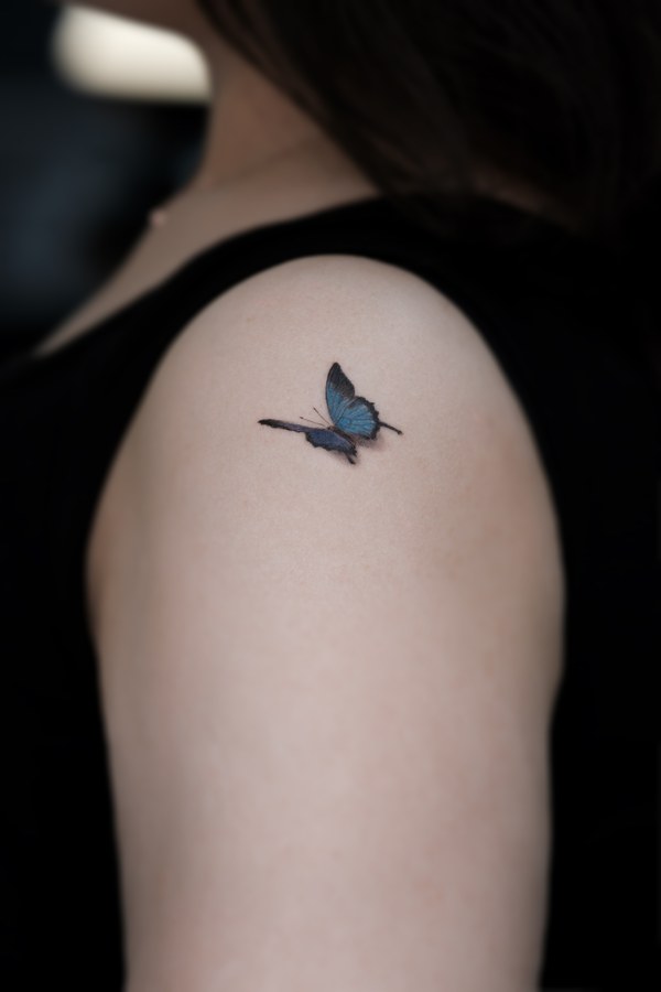 A butterfly covering a scar on the shoulder