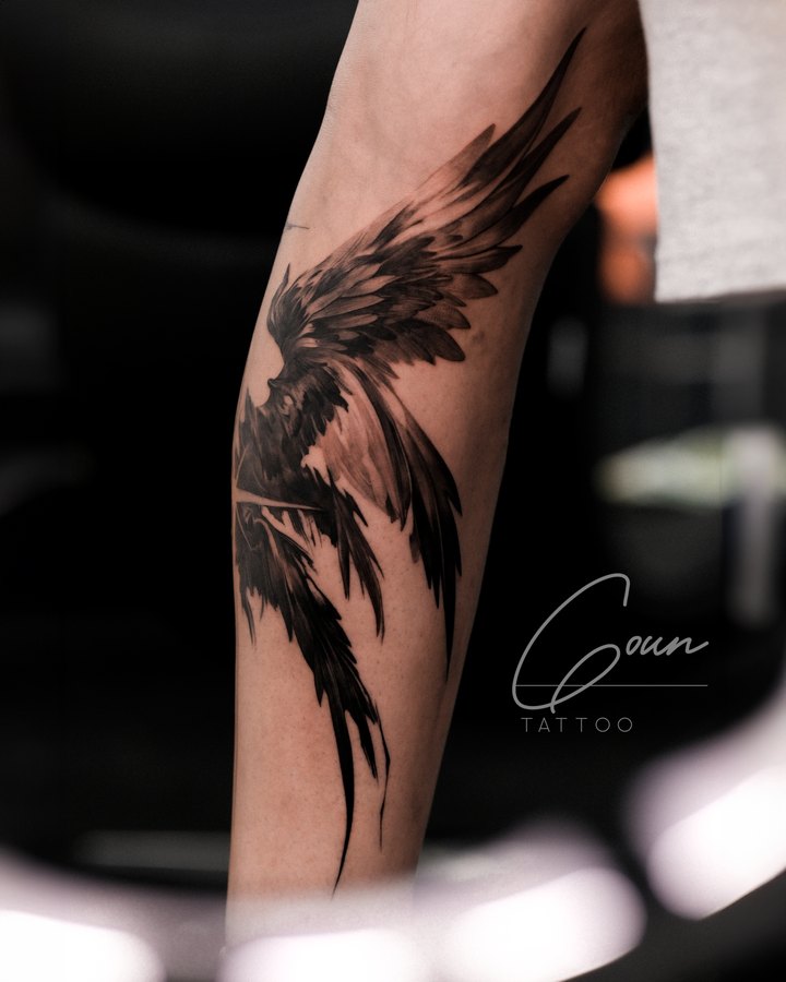 An illustrated wing tattooed on the leg