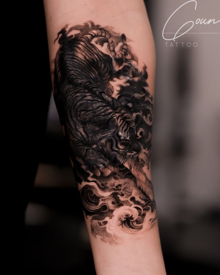 A tiger and waves covering an older tattoo