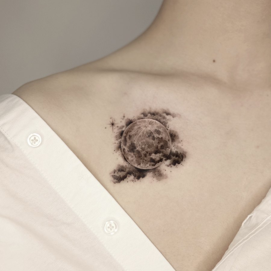 A moon tattooed on the collarbone