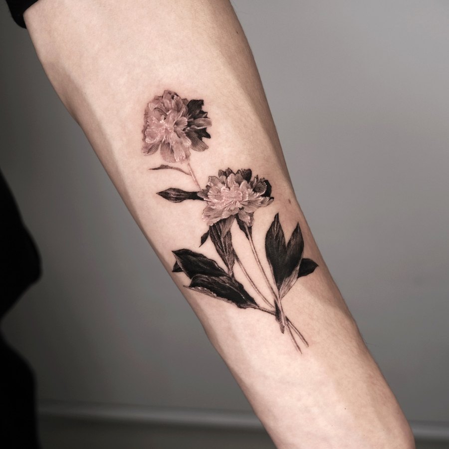 A bunch of peonies tattooed on the arm
