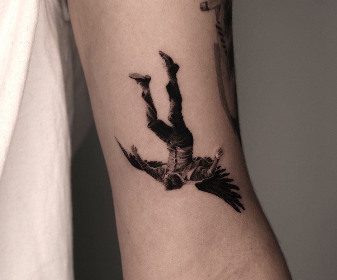 A falling figure tattooed on the arm