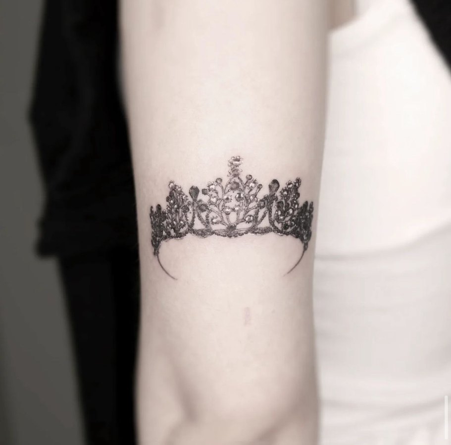 A crown tattooed on the arm
