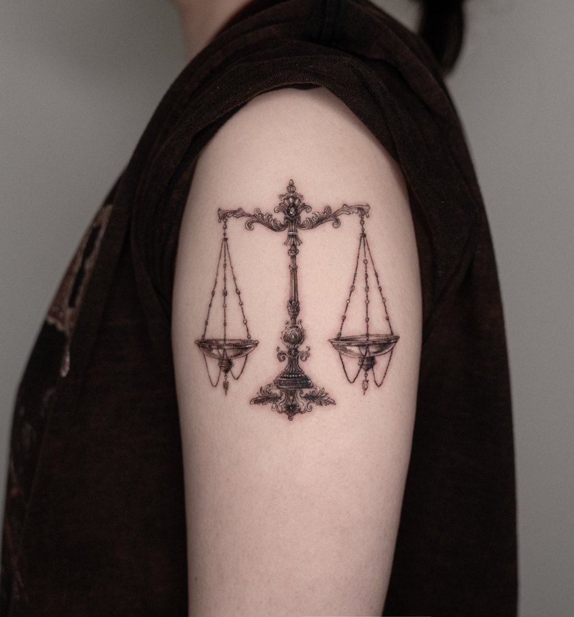 A set of scales tattooed on the shoulder